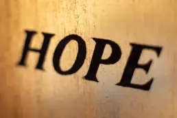 Stained glass window saying HOPE