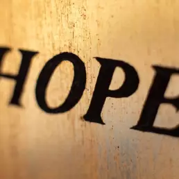 Stained glass window saying HOPE