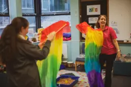 Play therapist and child using movement and play materials during a therapeutic session.