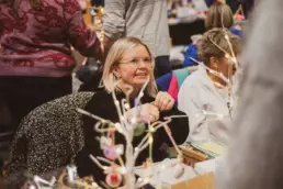 Visitors enjoying conversations and browsing handmade stalls at the Twilight Market in Derryvolgie Hall