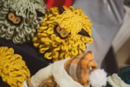 Close-up of handmade woollen sheep and festive gifts on display at the Twilight Market in Derryvolgie Hall