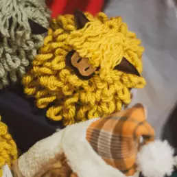 Close-up of handmade woollen sheep and festive gifts on display at the Twilight Market in Derryvolgie Hall