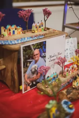 Miniature handmade village scene with colourful houses and trees created by a local artisan